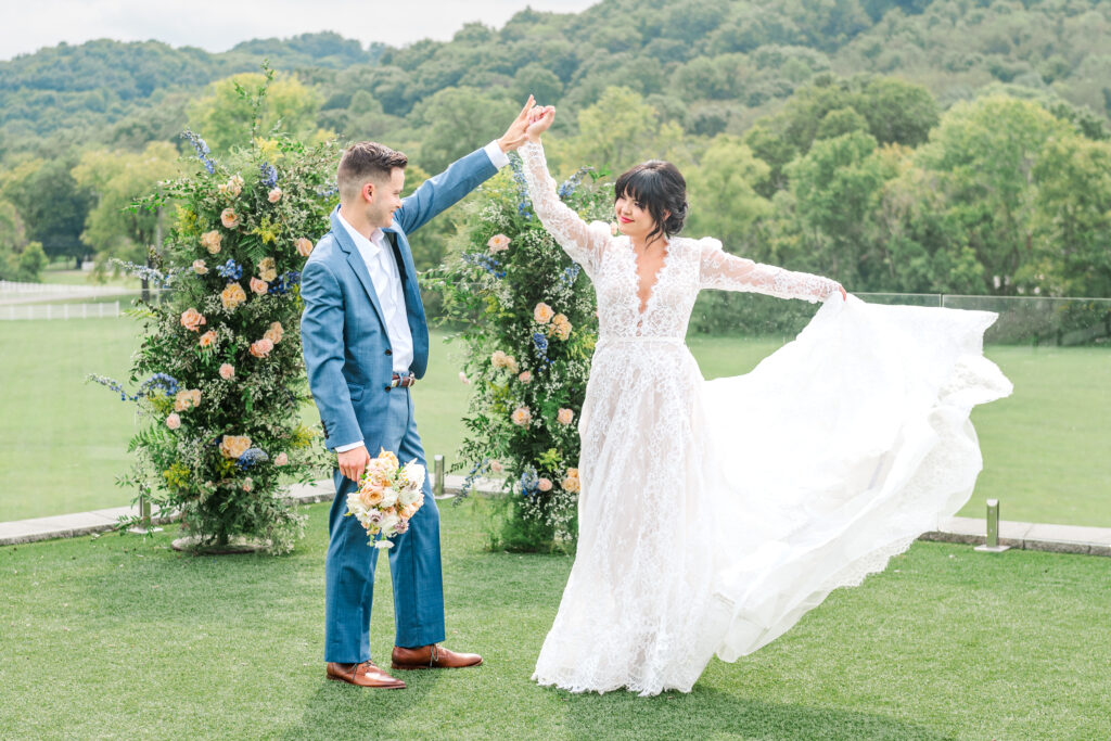 Lexington wedding bride and groom twirling with vibrant floral arch