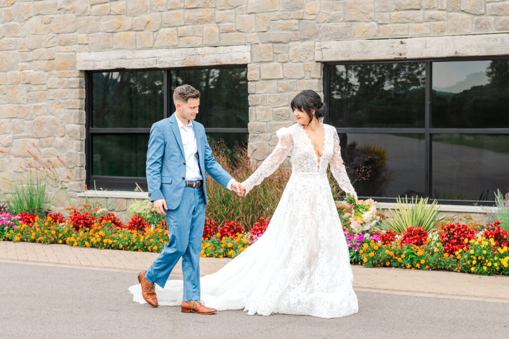 Lexington bride leading her groom on a stroll in front of their Lexington wedding venue