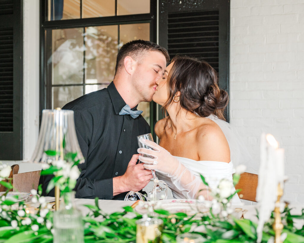 bride and groom kissing during wedding reception in lexington