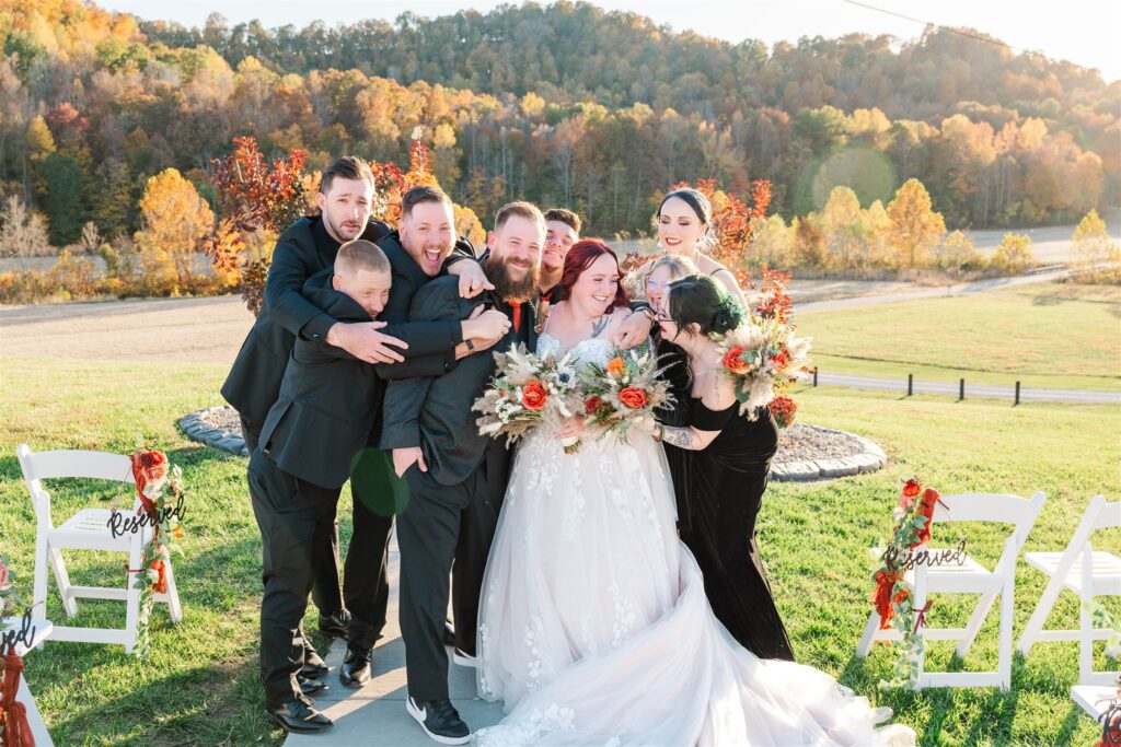 bridal party embracing bride and groom at lexington wedding