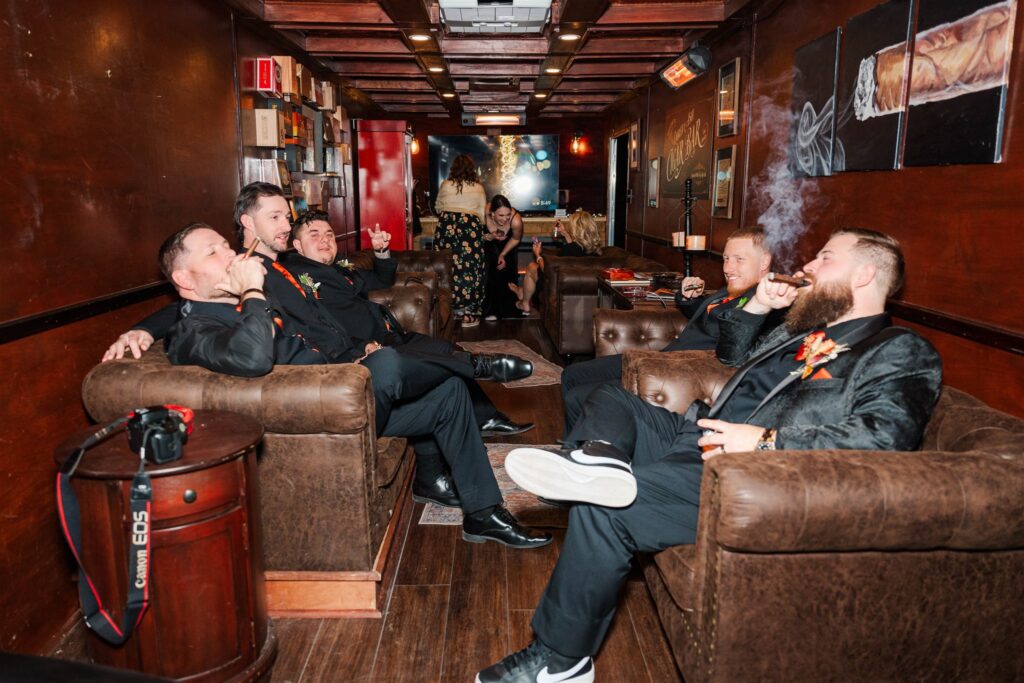 groom and groomsmen enjoying cigars from mobile cigar lounge at lexington wedding